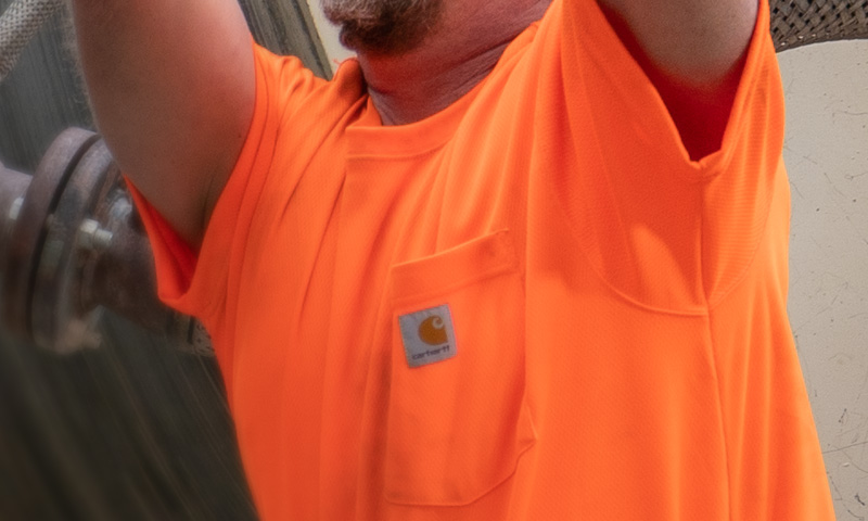 Worker in an orange hi-vis work shirt